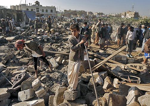 Searching through the rubble left behind after a Saudi air strike in Yemen